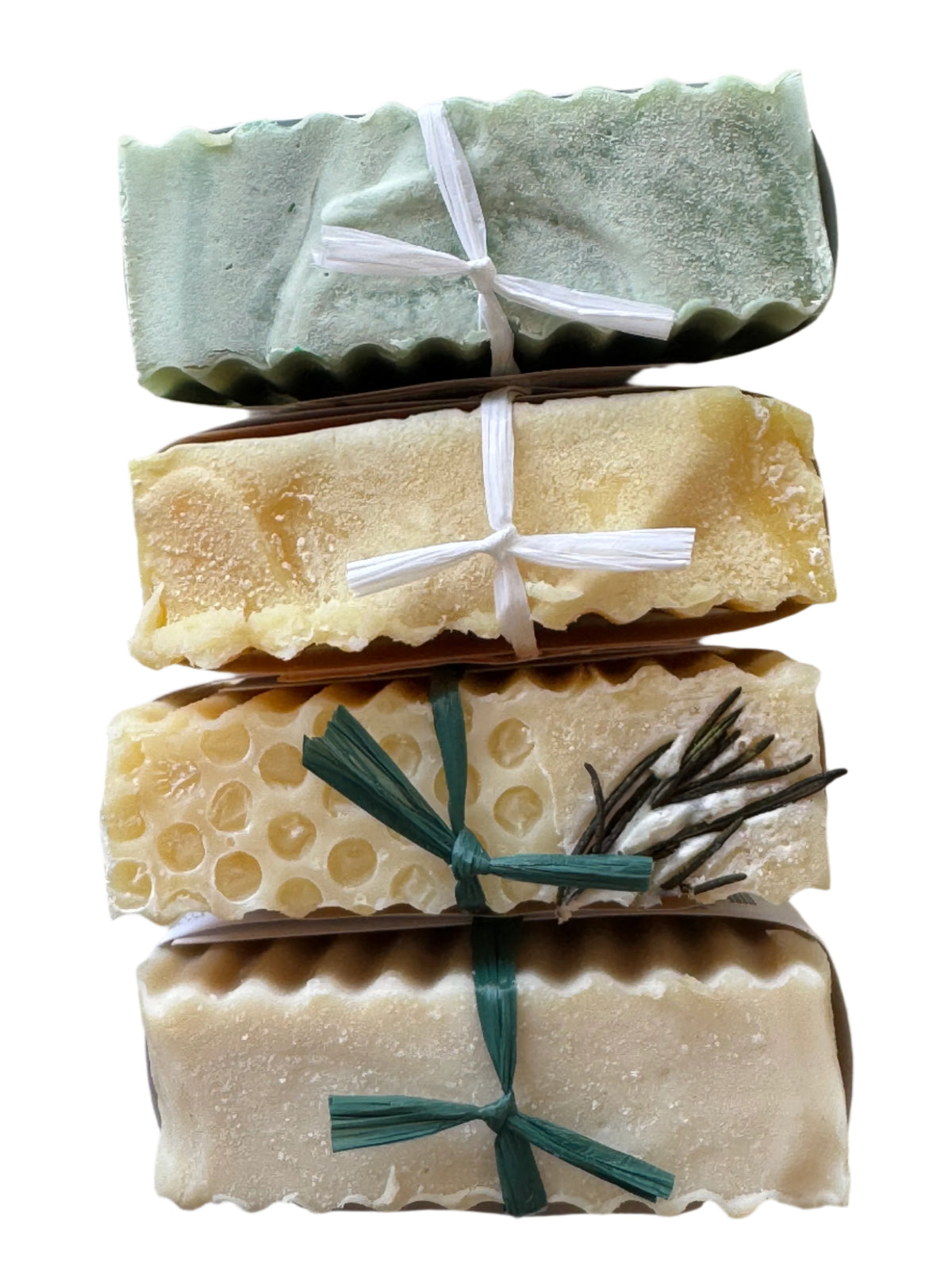 Four bars of soap with decorative elements on a light background