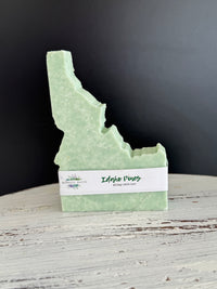 Pine Scented Idaho Shaped Bar soap with wood and black background